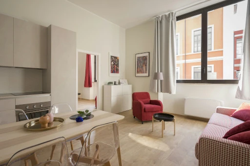 room lined in white with two red couches